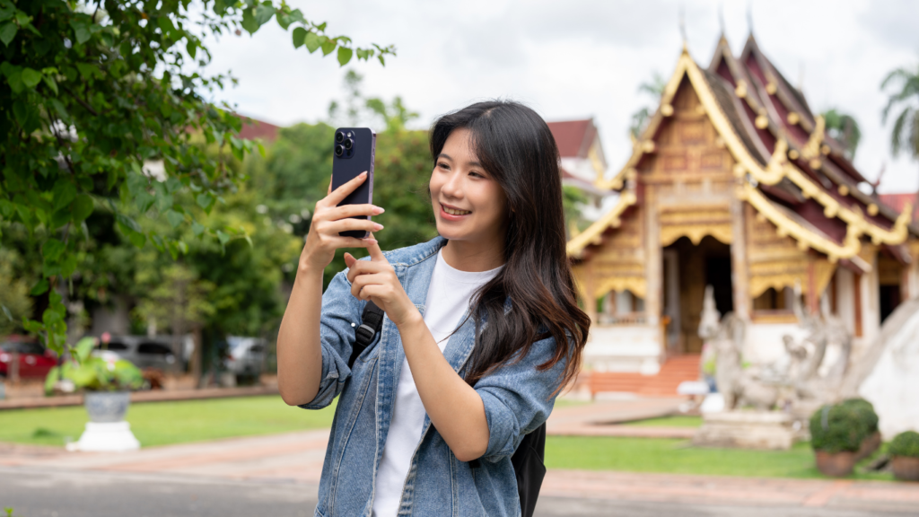 Tourist using phone near temples